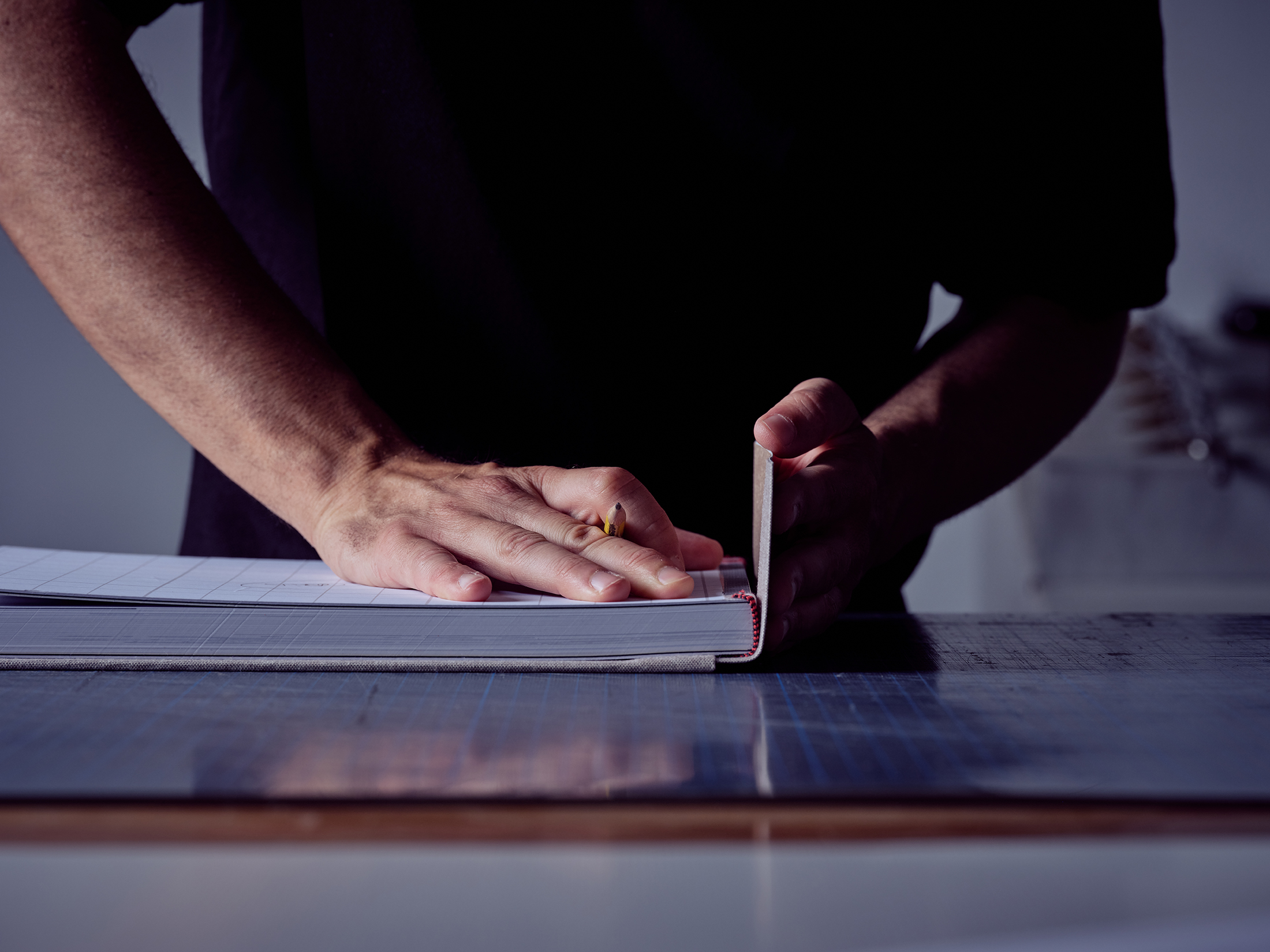 Faceless Man Making Book Cover While Working At Workshop